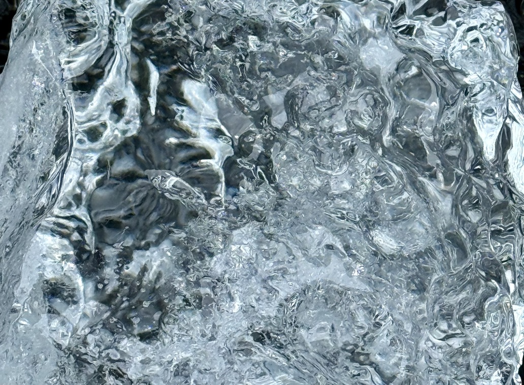 Intricate transparent patterns and bubbles in a piece of ice