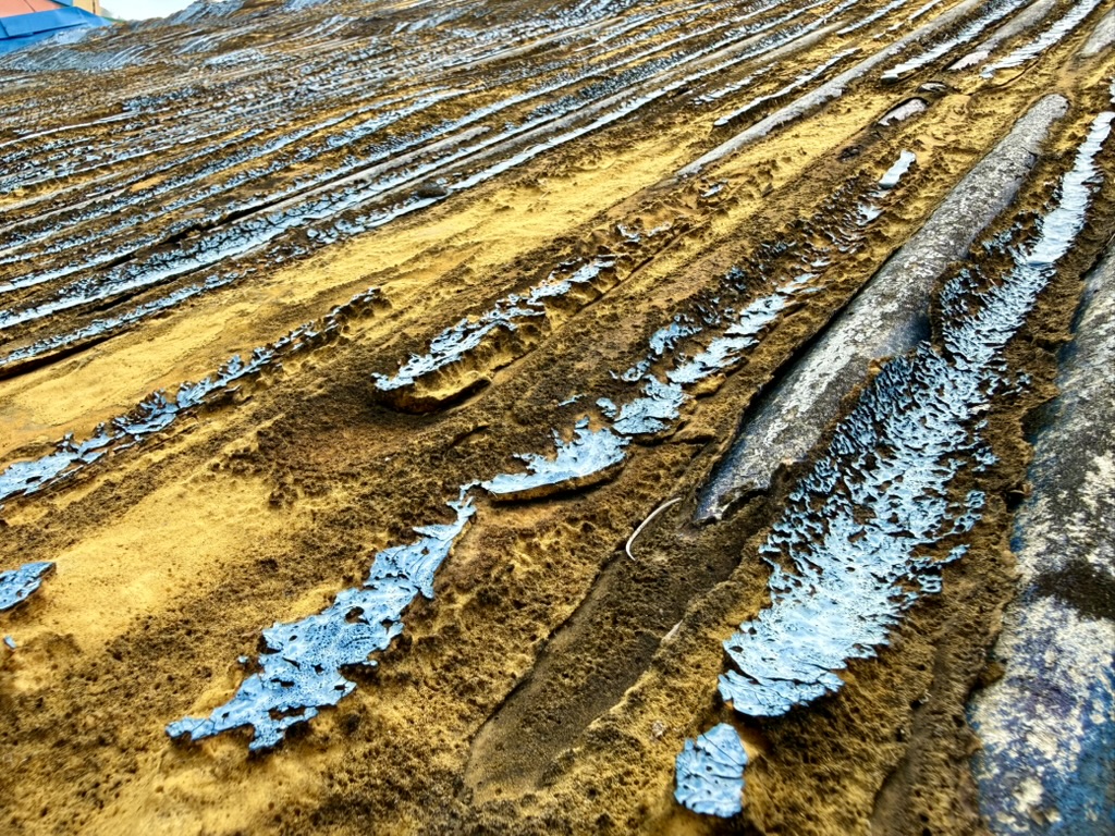 Weathered blue paint and ochre texture
