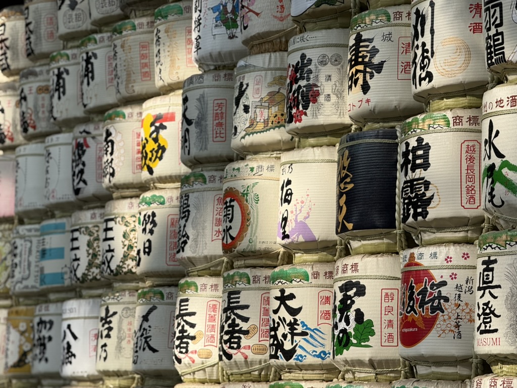 A wall of decorated sake barrels