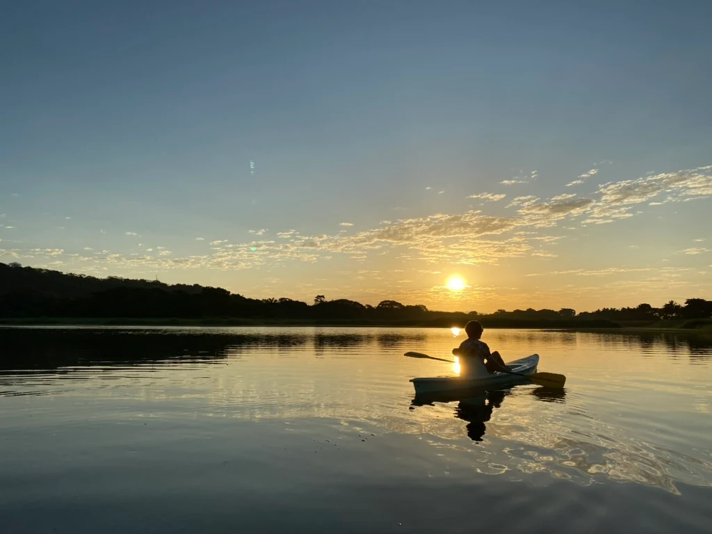 A kayaker silhouetted against the sunrise